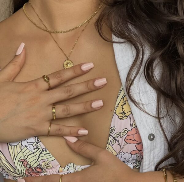 A woman with her hands on her chest.
