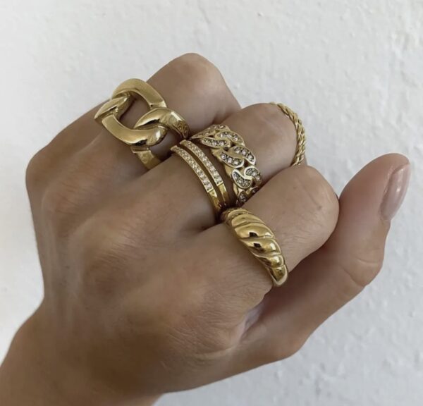 A hand with several different rings on it