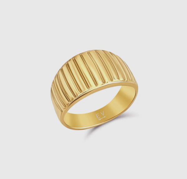 A gold ring with a row of lines on it